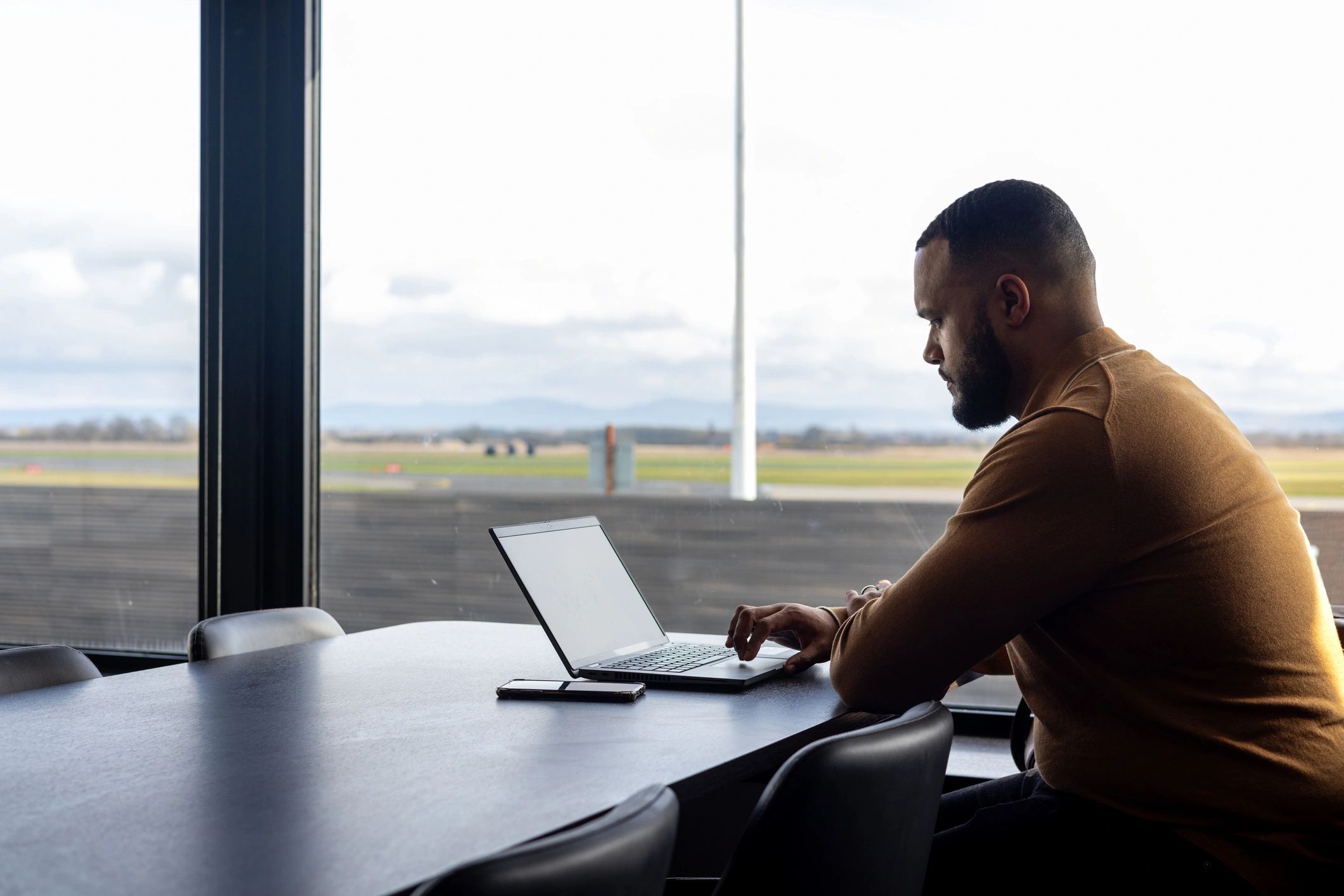 Traveler working in an airport lounge before departure