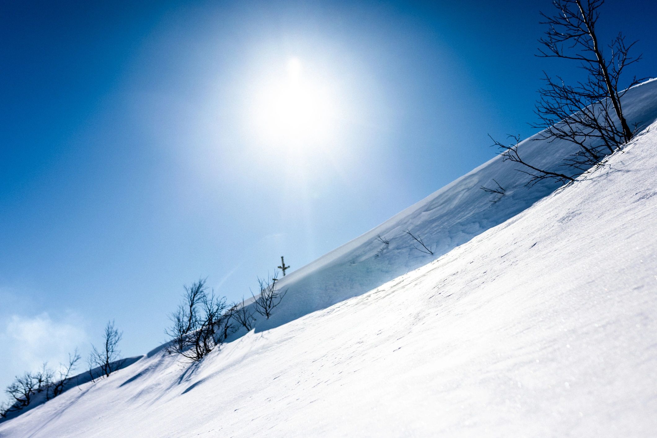 Snowy alpine slope under a clear blue sky